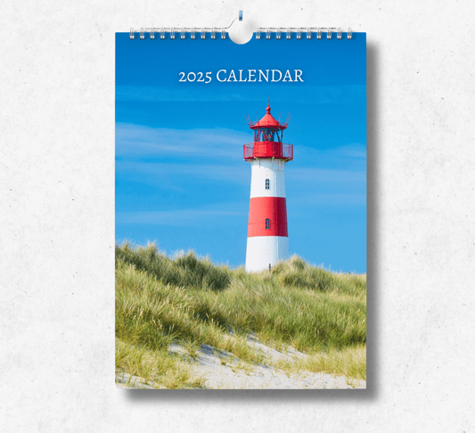 2025 Lighthouse calendar featuring red and white striped lighthouse upon a grassy beach head.